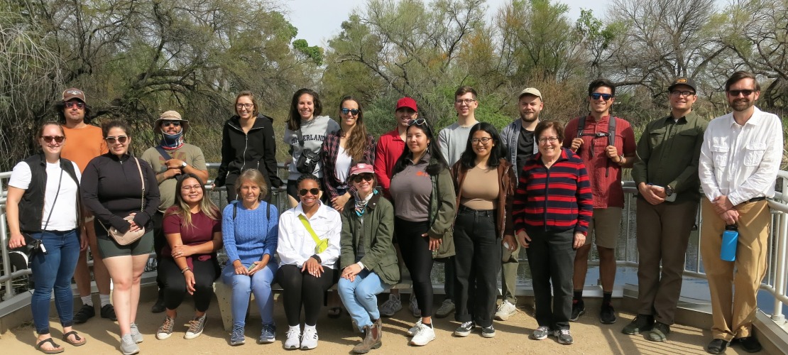 A group of students poses for a photograph at the Sweetwater Wetlands in Tucson, AZ.